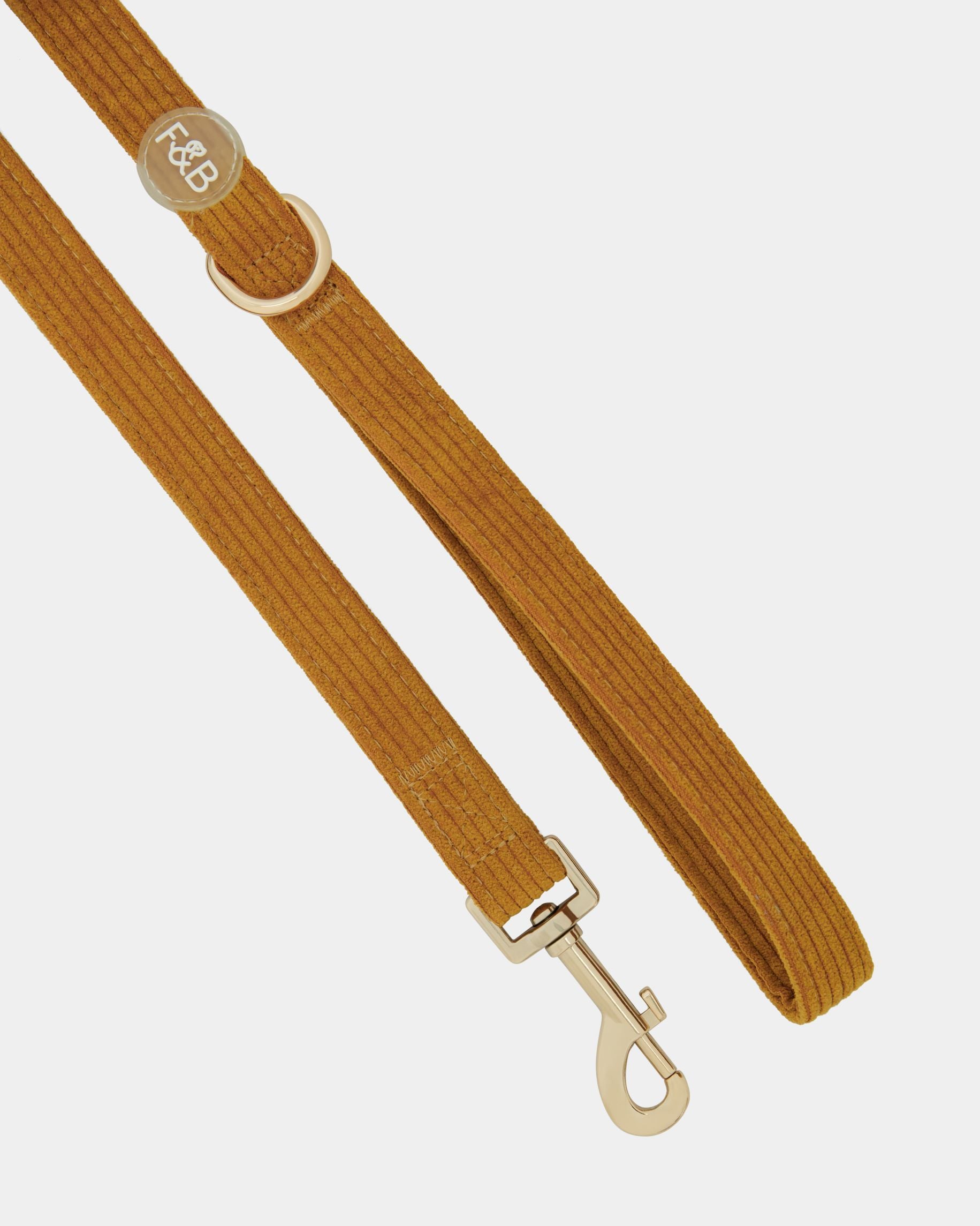 Close-up of the Fetch and Bark Corduroy Lead in Ochre, featuring a luxurious corduroy texture, durable gold hardware, and a high-tensile clip for a secure and stylish walking experience. Length: 147cm for the perfect fit and control.