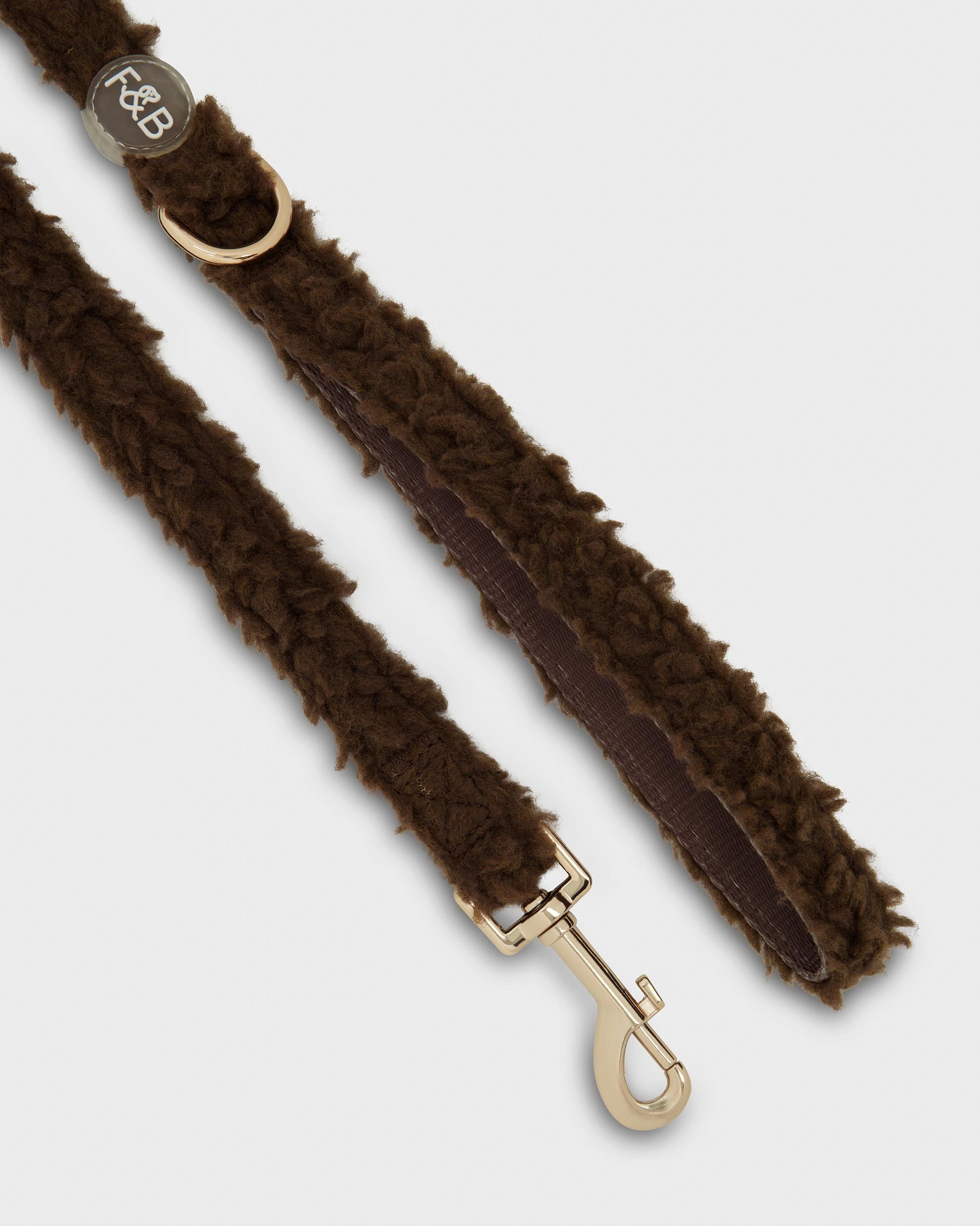 Close-up of the Fetch and Bark Boucle Lead in Chocolate brown, featuring a boucle texture, durable gold hardware, a high-tensile clip for secure attachment, and a convenient gold D-ring for adding the matching waste bag holder.